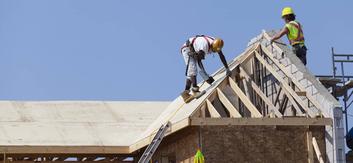 Men building a roof.