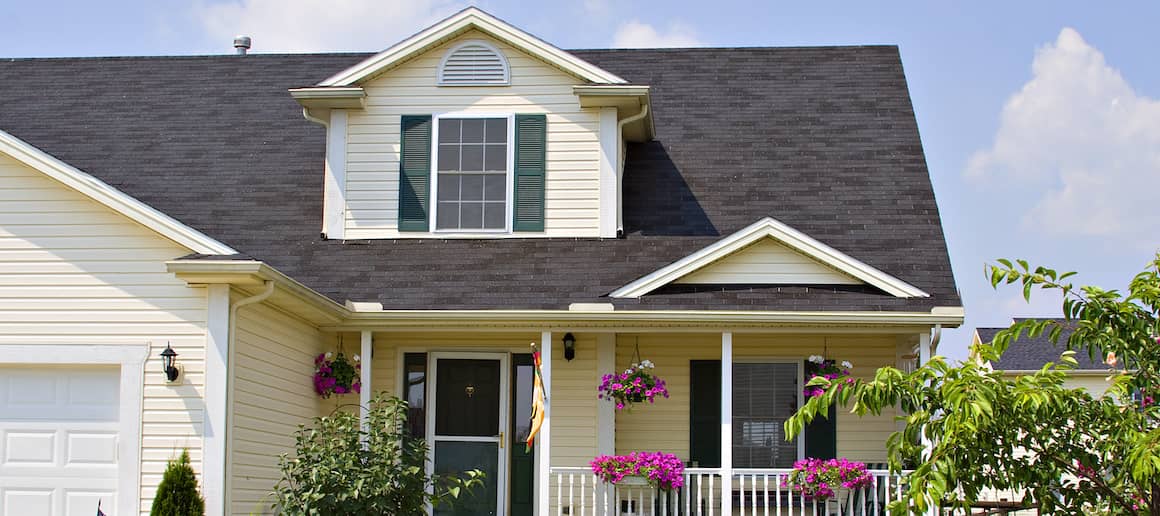 exterior of front of 2-story yellow house with front porch
