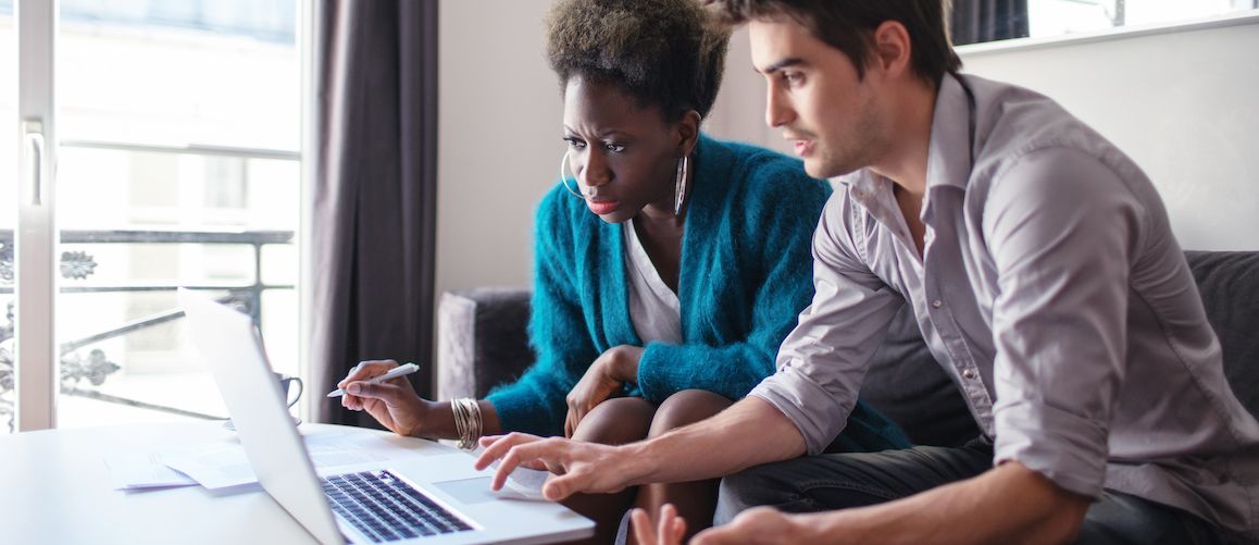Young couple looking at a computer.