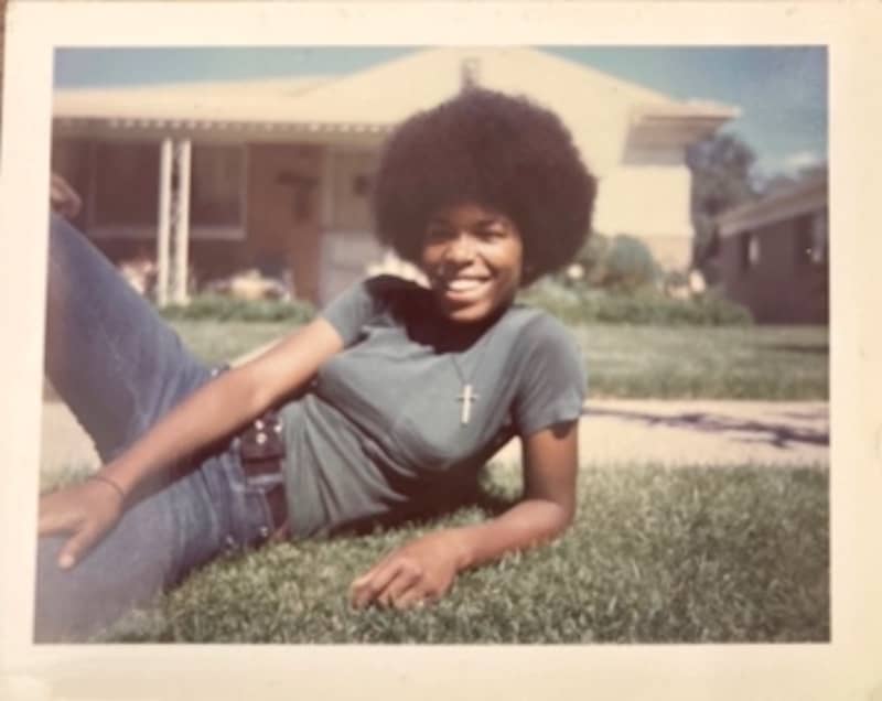 Teresa relaxed on a front lawn.