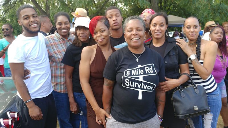 Teresa wearing 8 Mile Survivor shirt at the front of a group photo.
