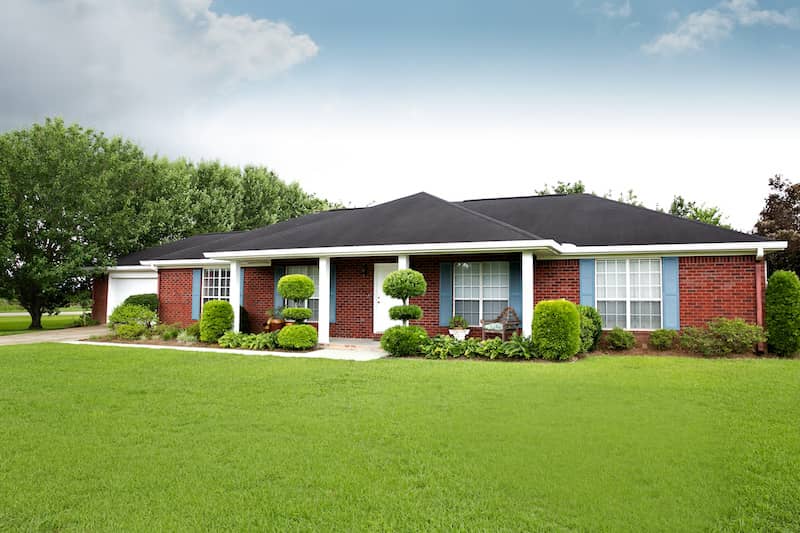 Red brick ranch style home.