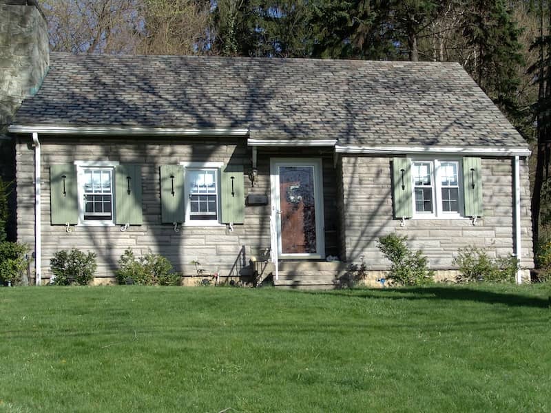 Small gray cape cod style home.