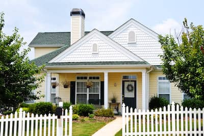 Adorable white and yellow cottage.