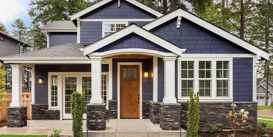 Large blue house with white accents and trim.