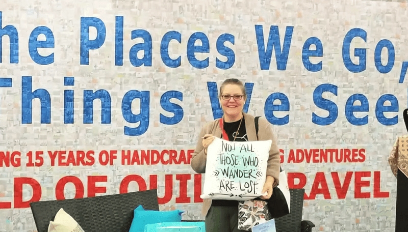 Rona Herman posing at a quilting event.