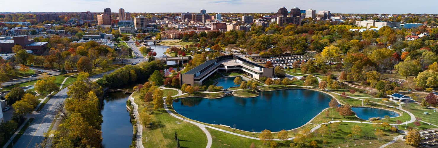 Aerial view of Kansas City showing lots of trees interspersed among water and buildings.