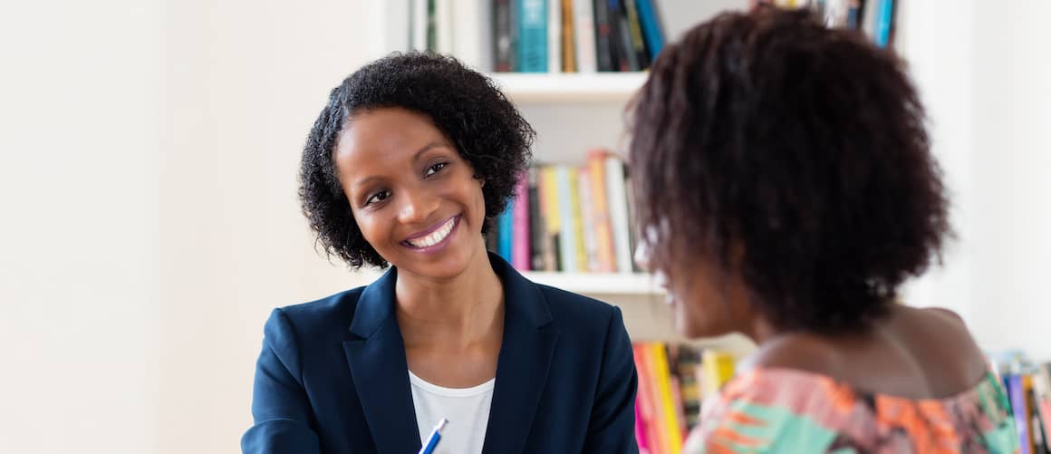 African-American woman signing contract.