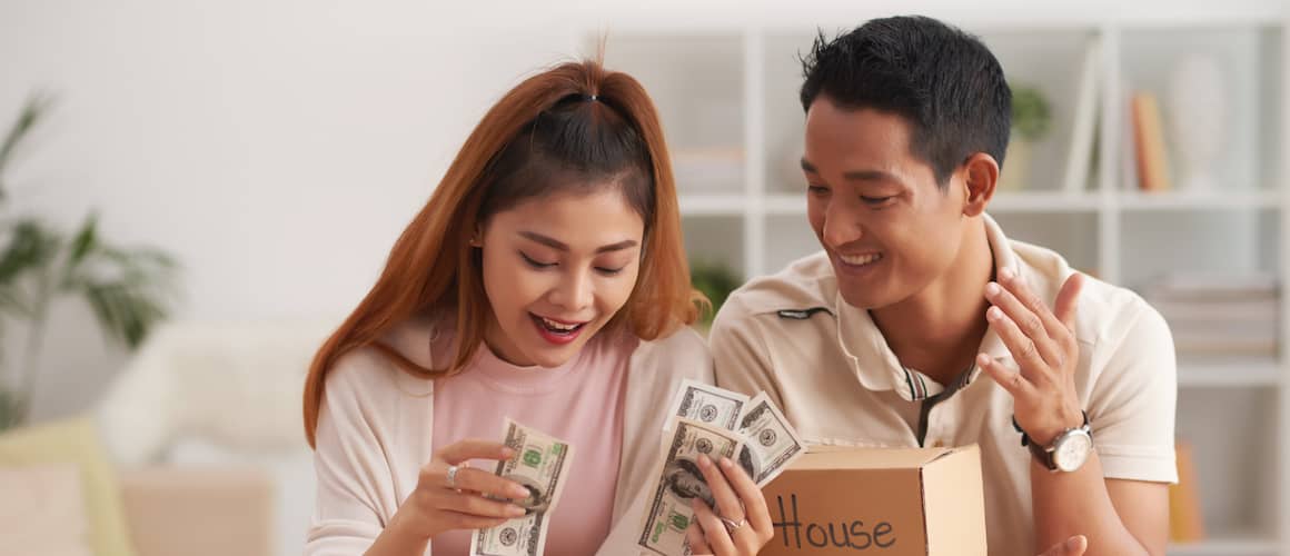 Young Asian couple look at their savings.