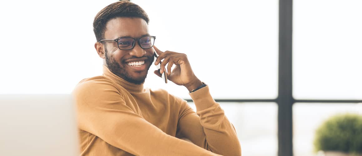 African American man on phone happy.