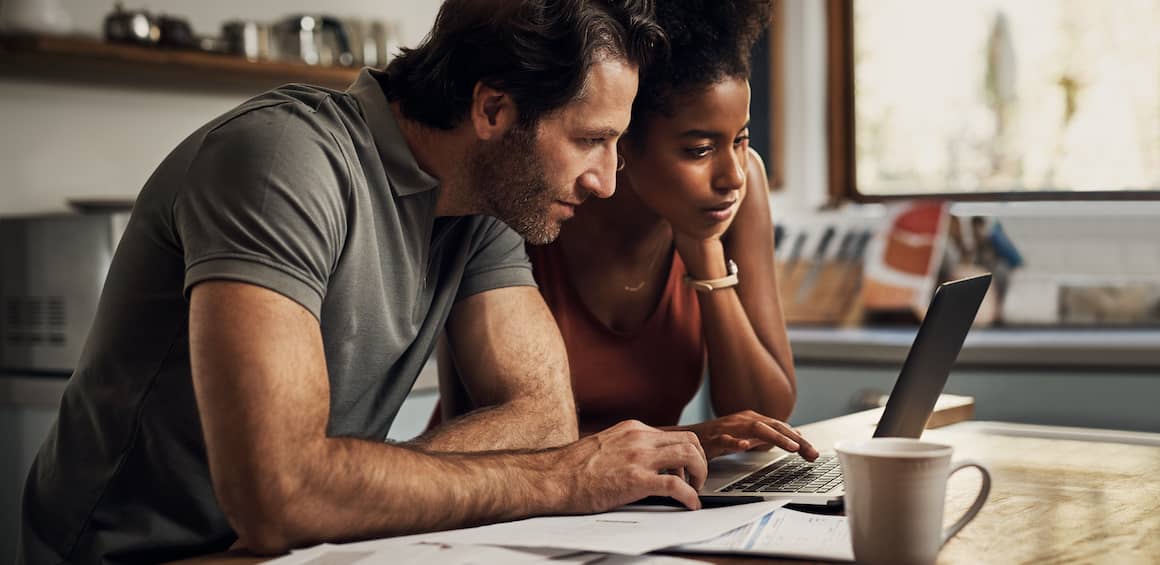A couple working on their finances on their laptop.