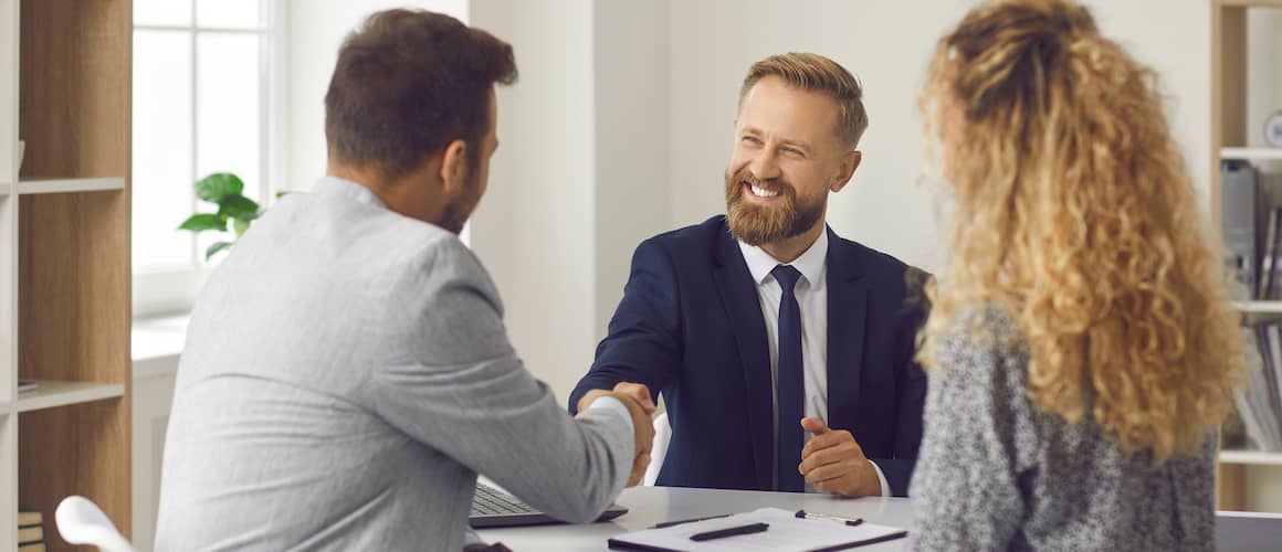 Financial Advisor Shakes Hands With His Clients