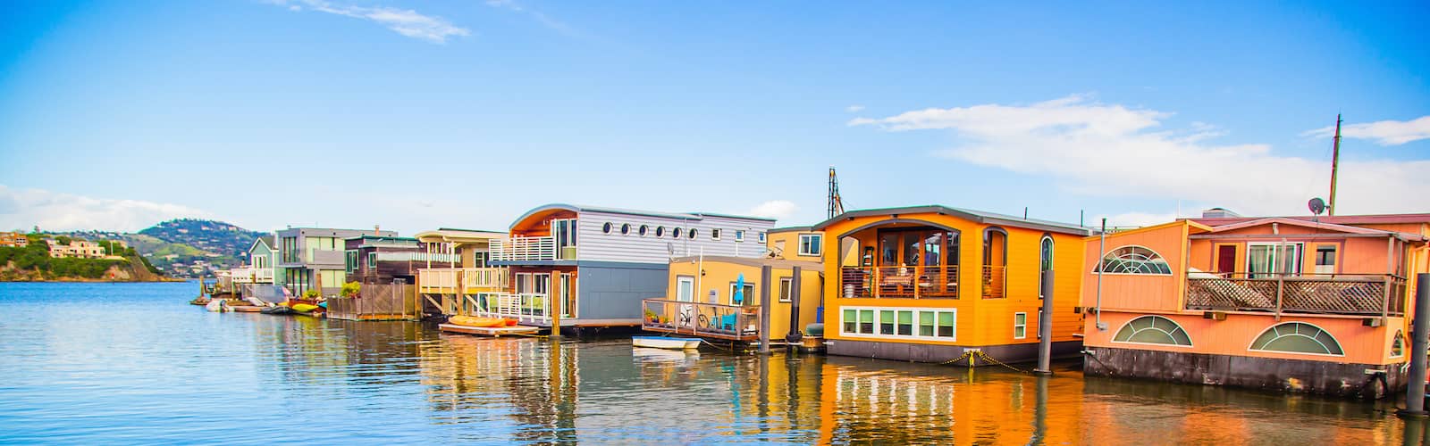 Colorful house boats floating on water in Sausalito.