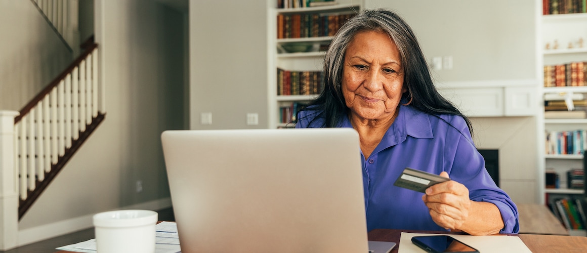 Elderly Native American woman checks her credit score.