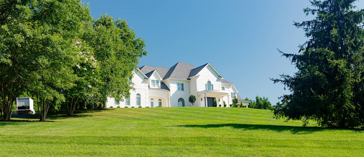 Large white house with lawn.