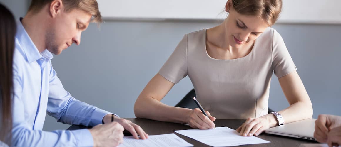 Business partners signing contracts.