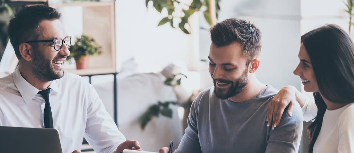 Man goes over new mortgage with couple.