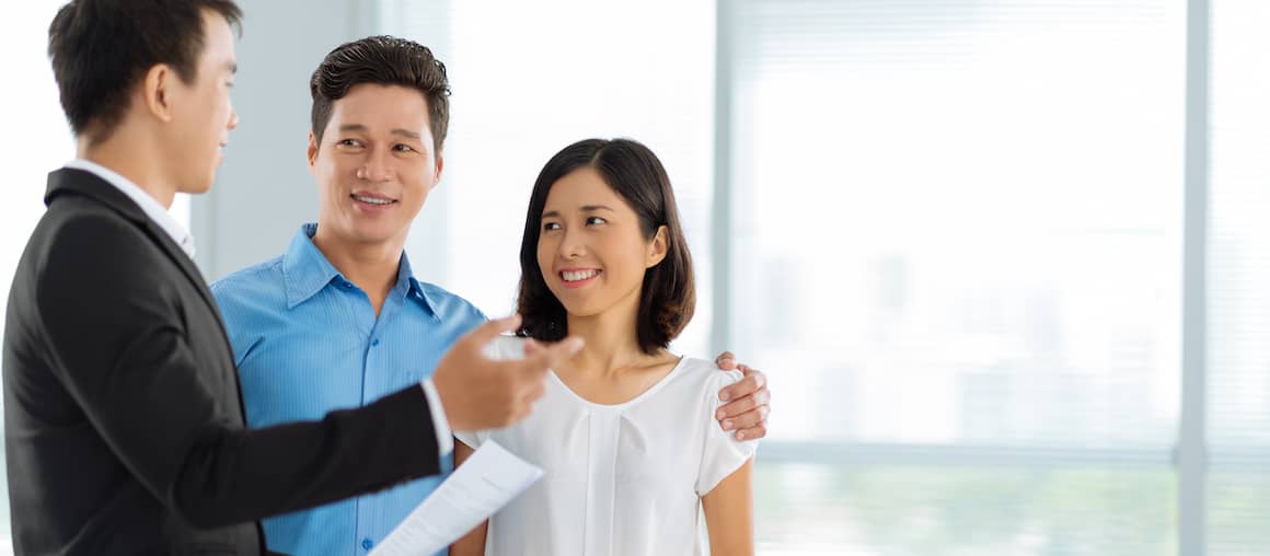 Realtor shows house to Asian-American couple.