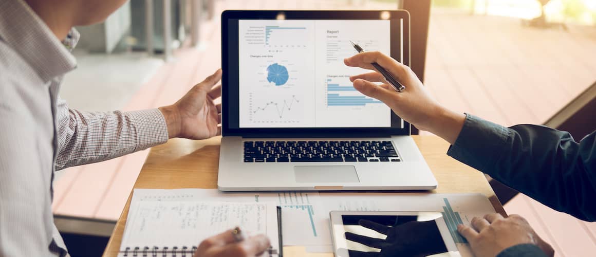 Business people reviewing data online.
