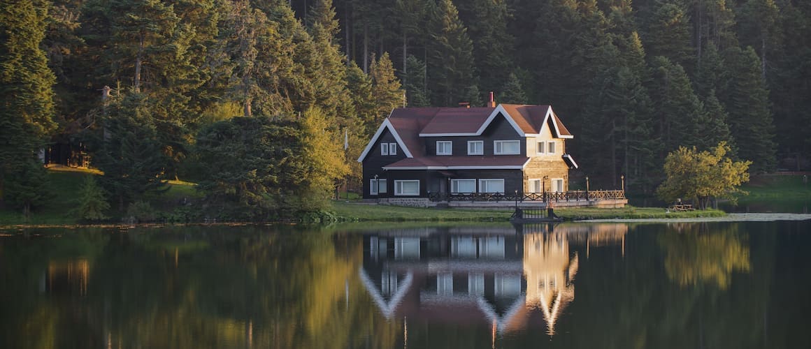 Nice multi-story house on the edge of a lake.
