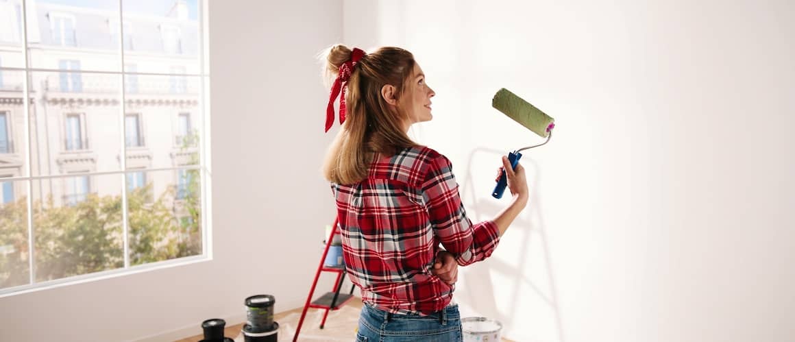 Woman Painting Home In Green