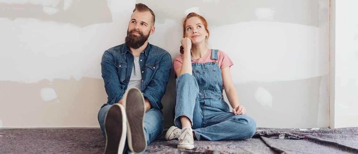 Couple sitting on the floor side by side.