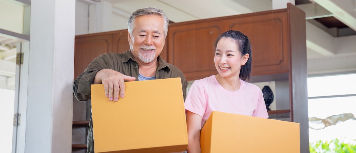 Young Asian woman moves into new home with senior father.
