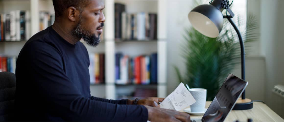Man entering in his gross income from his pay stubs online.