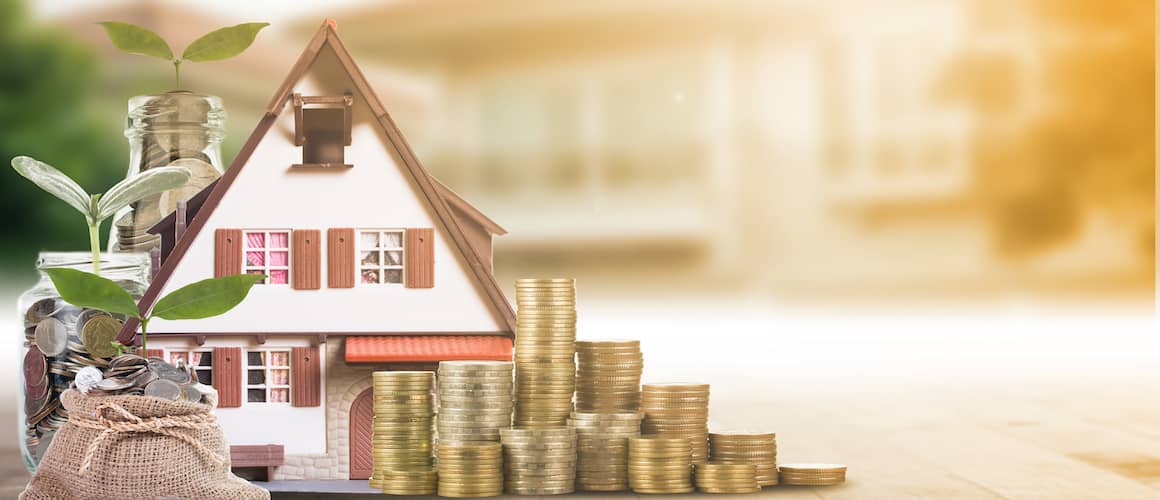Model of a house with stacked coins and glass jars with green sprouts to symbolize growing home equity.